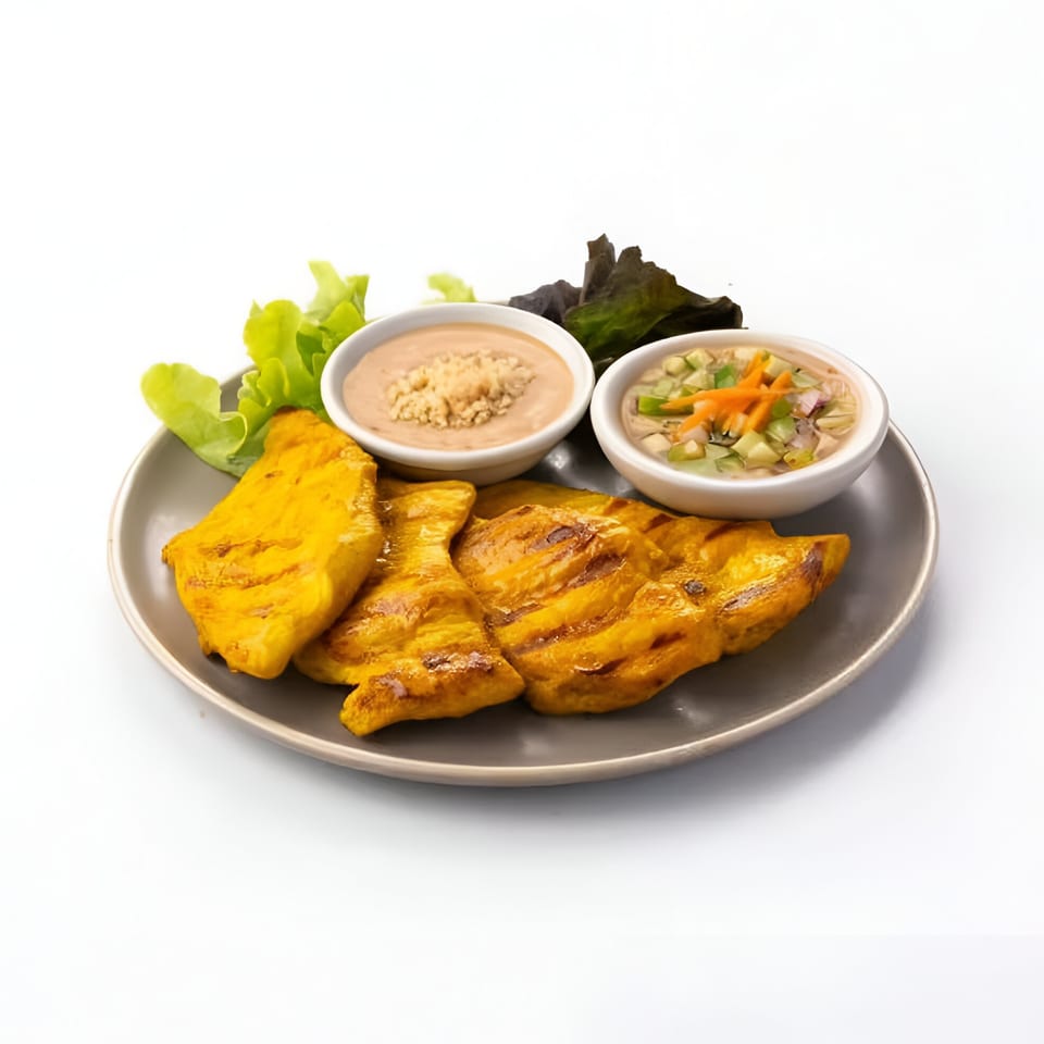 Skye Thai's grilled chicken satay with peanut sauce, cucumber relish, and fresh lettuce on a gray plate.