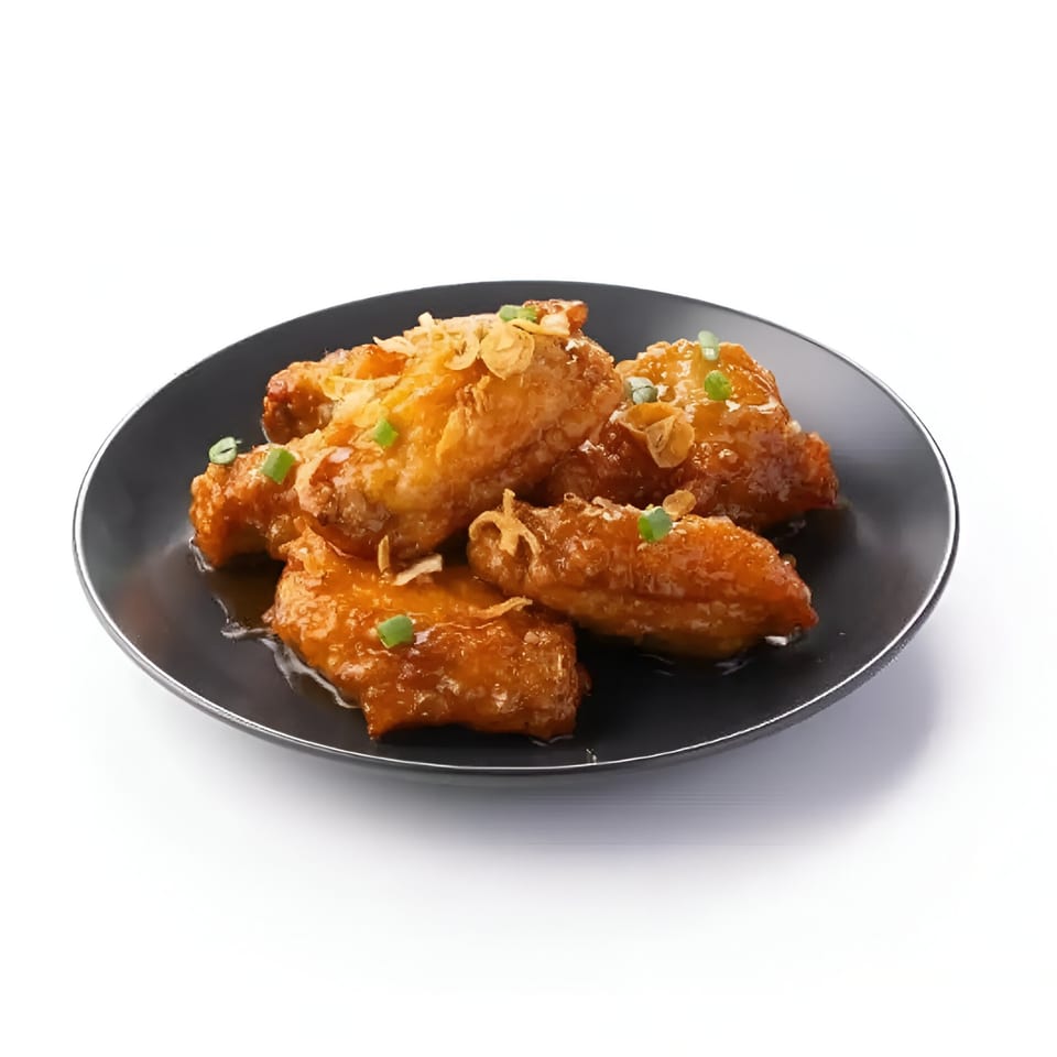 Skye Thai's crispy chicken wings, glazed in a sweet sauce, garnished with fried shallots and scallions.